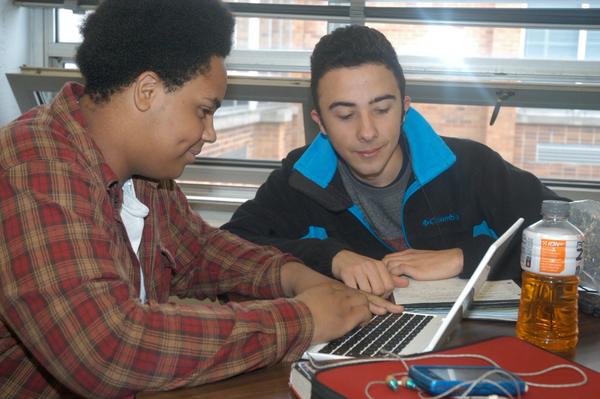 2 students using a laptop