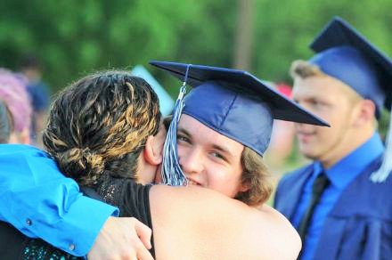 student hugging parent during graduation